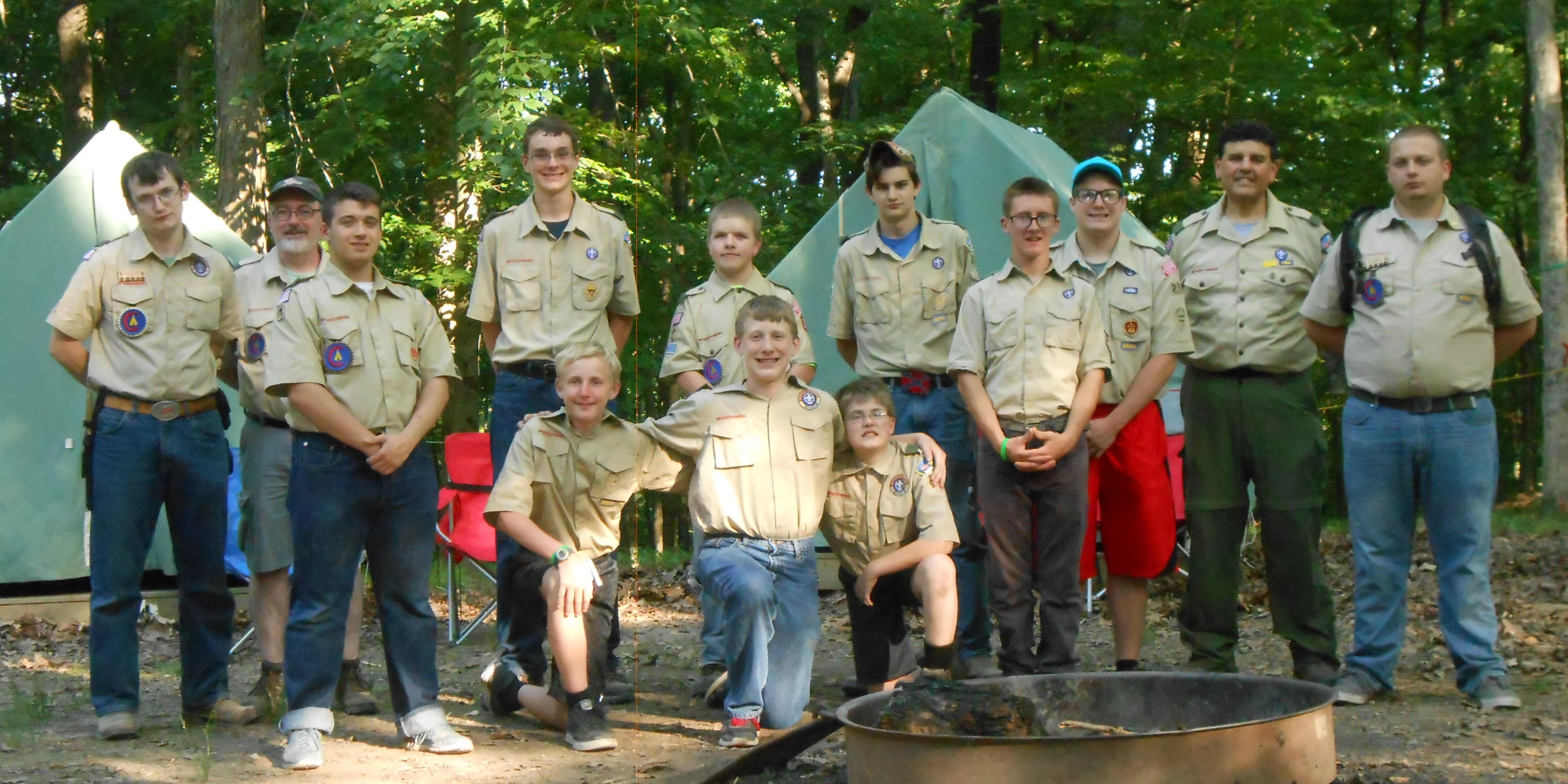 A group photo of Boy Scout Troop 227 in a campsite at Ransburg Scout Reservation